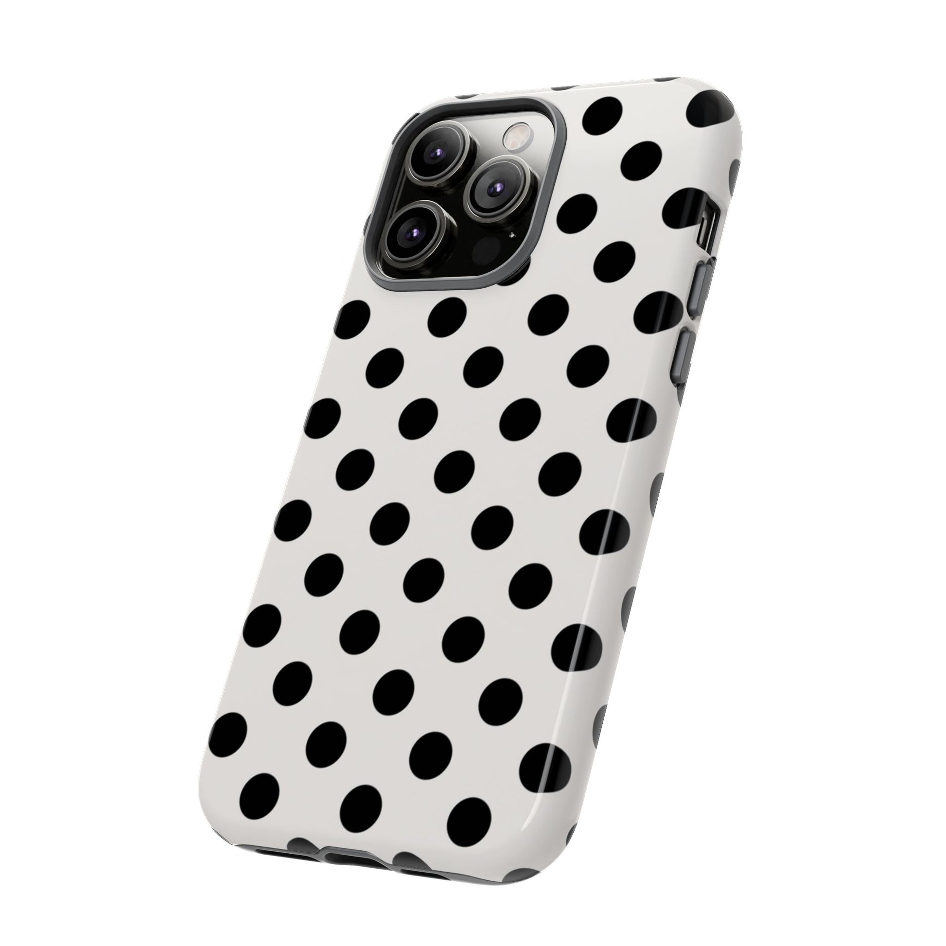 Black polka dot tough phone case on white background showing slim profile and wireless charging compatibility
