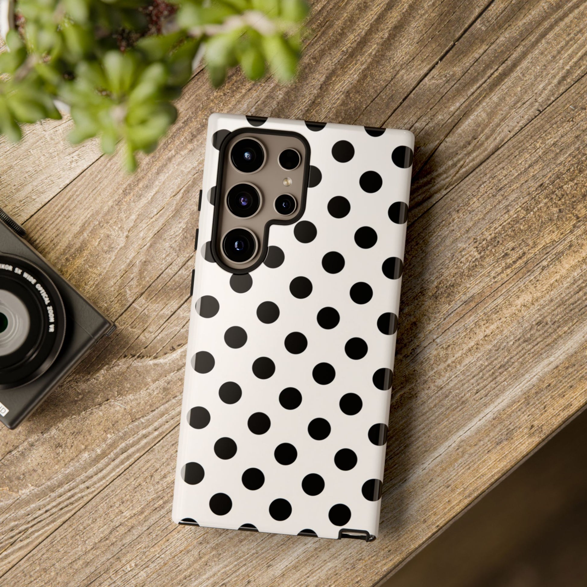 Black polka dot phone case corner detail showing shock absorption protection and raised edges
